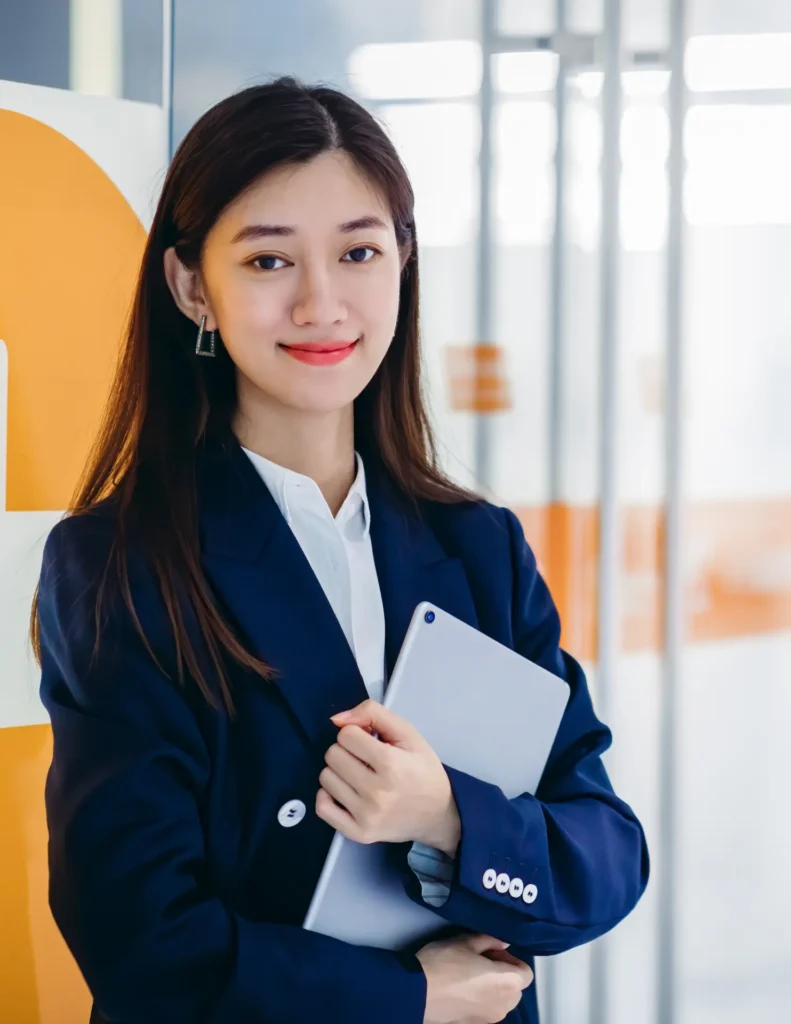 A woman in a business suit holding a tablet at our Virtual Assistant companies