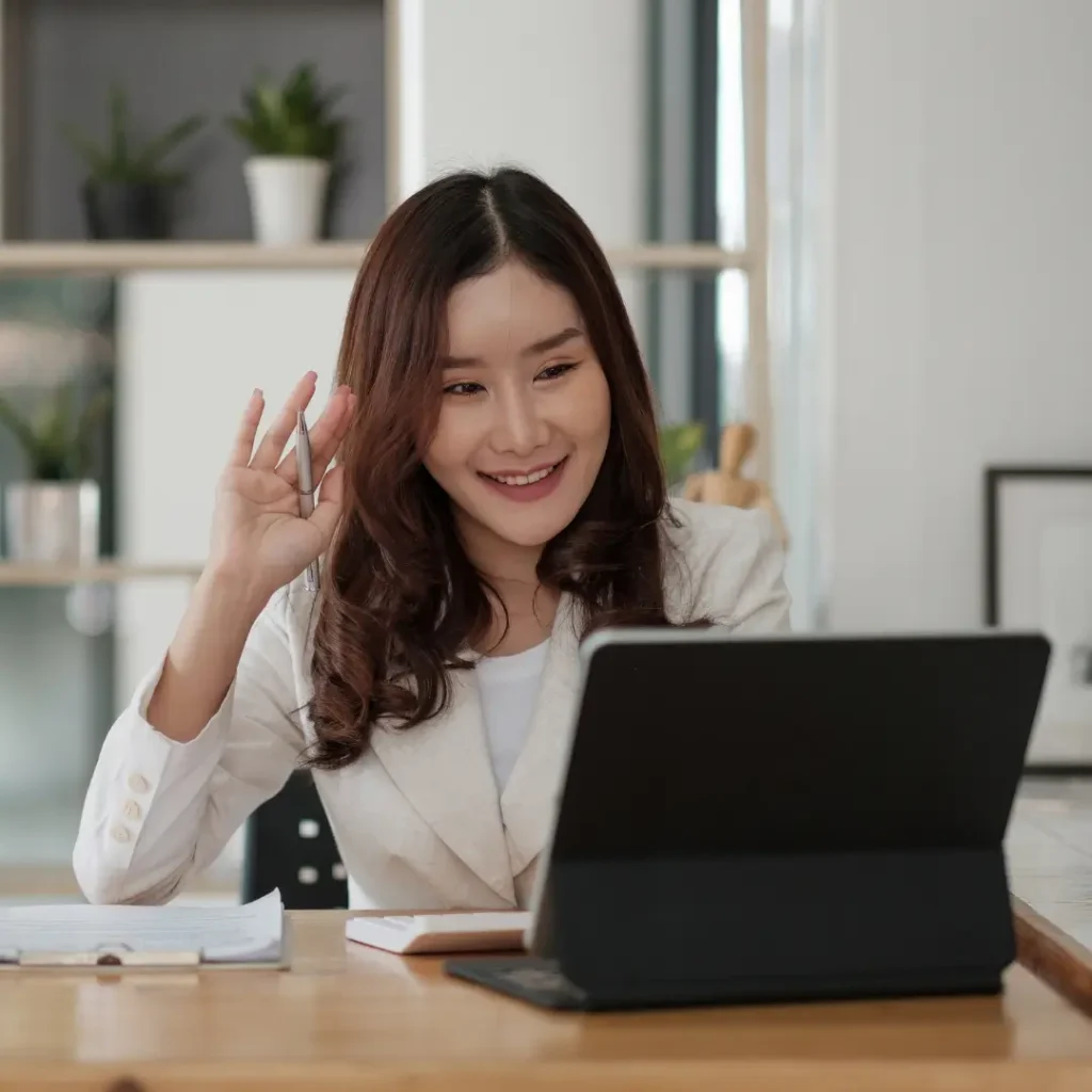 A woman working at our virtual assistant agency sitting in front of a laptop computer.