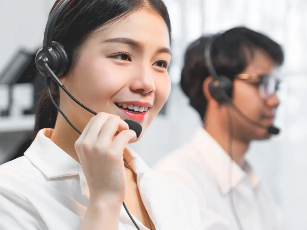 A woman wearing a headset and smiling at the camera